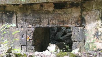 Hieroglyphen und ein Schmetterling verzieren dieses halbverschüttete Tor